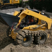 McLaren Rubber over-the-tire tracks with solid cushion tires on a skids teer loader